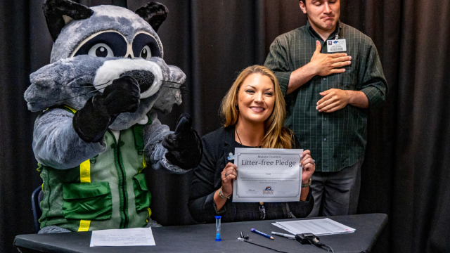 Rubbish the Raccoon taking the litter-free pledge